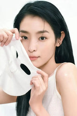 Model holding a glossy sheet mask next to the face against a clean white background, Ceramide Hydrating Mask
