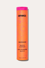 Amika Normcore Signature Conditioner bottle, a hydrating Detangling Conditioner for all hair types.