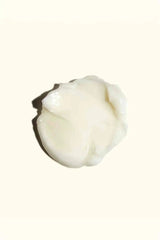 Rich, creamy texture swatch of Amika mask, infused with Jojoba Seed Oil for deep conditioning.