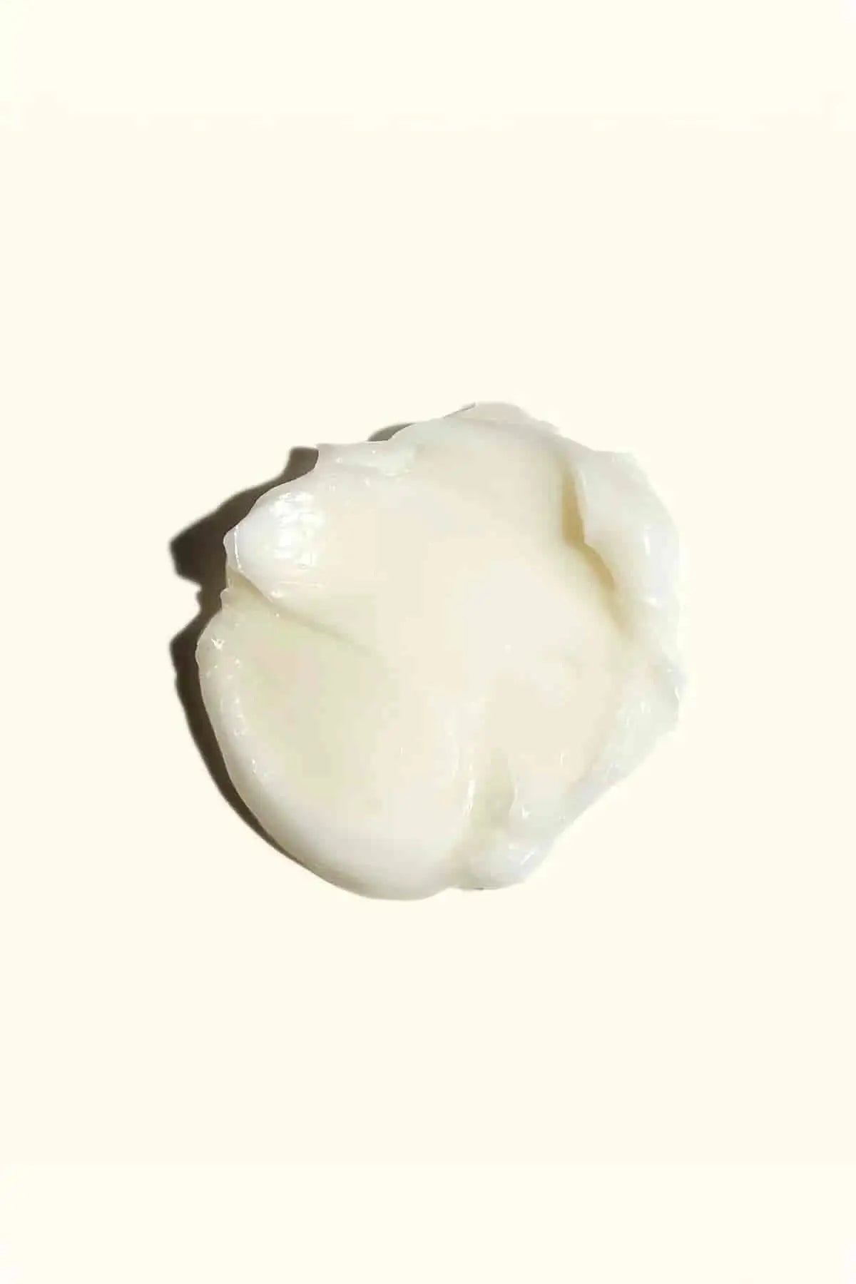 Rich, creamy texture swatch of Amika mask, infused with Jojoba Seed Oil for deep conditioning.