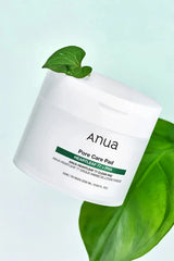Medicinal Heartleaf resting on the Anua TONER PADS jar, highlighting its natural ingredients for a refreshing Exfoliating TONER experience.